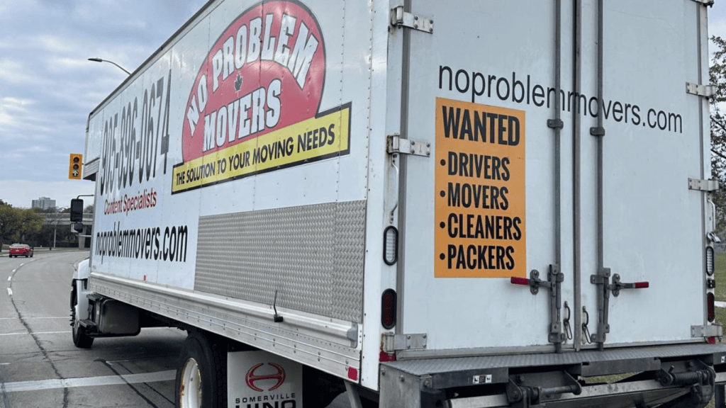 No Problem Movers moving truck parked on a Mississauga roadway, displaying company branding and contact information for residential and commercial moving services.
