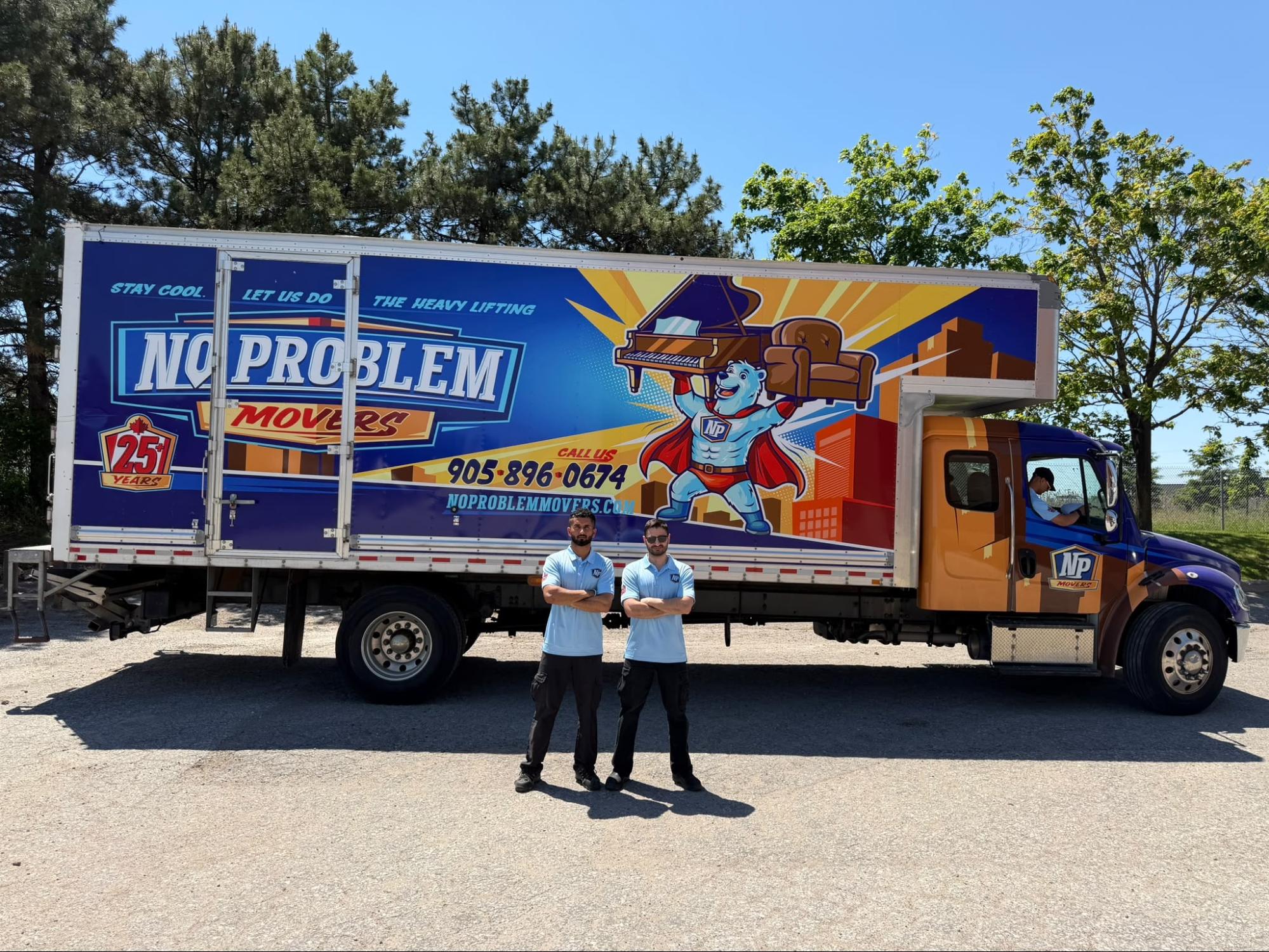No Problem Movers branded moving truck with two uniformed movers standing in front of it at the company's Mississauga location, showcasing professional moving services.