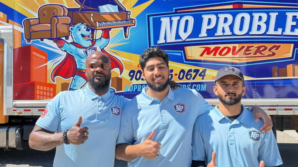 Three No Problem Movers team members standing in front of a branded moving truck in Mississauga, highlighting the company's professional residential and commercial moving services.